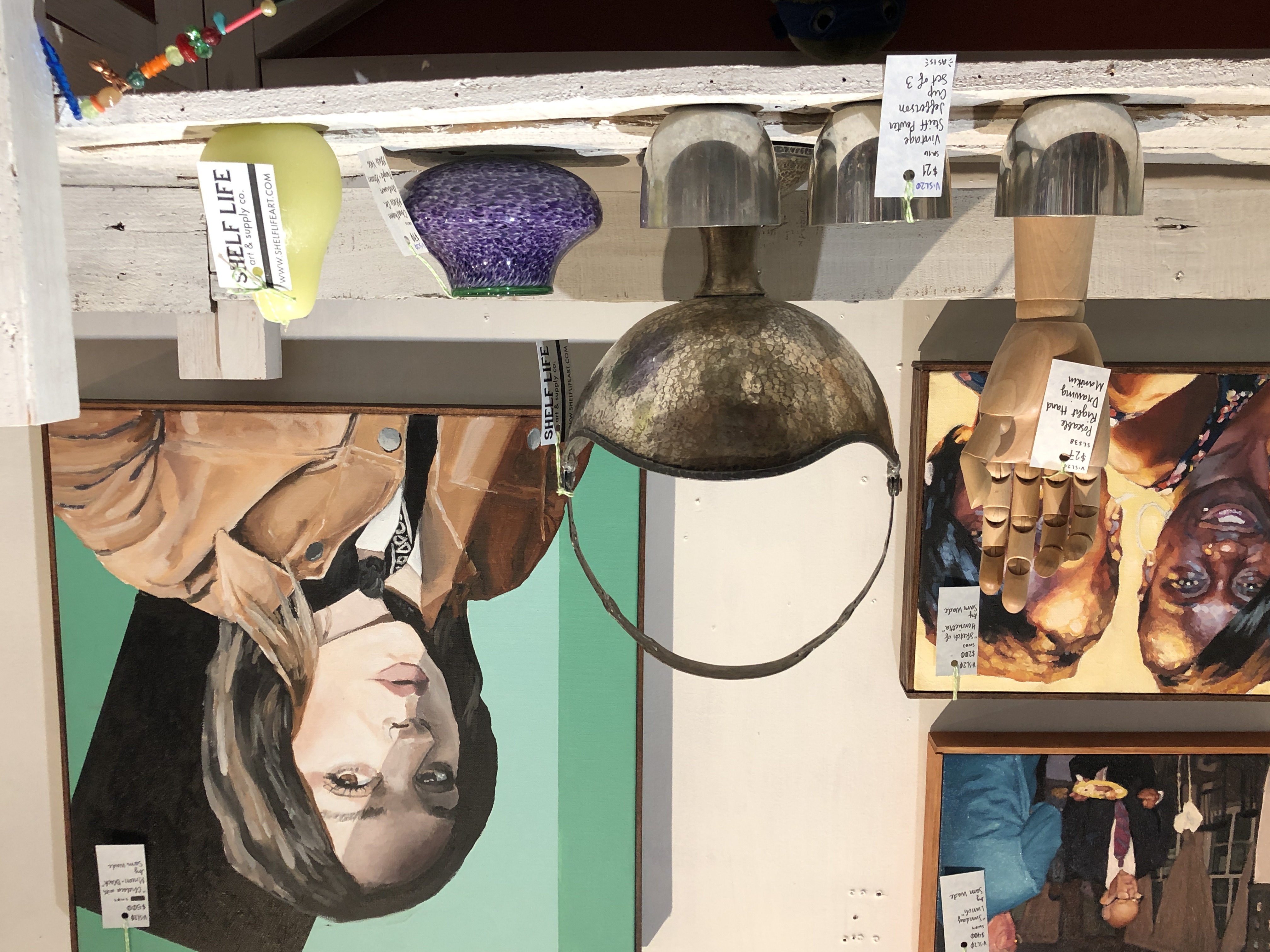 Oil portraits by Sam Wade, poseable right hand drawing manikin, vintage Steiff Pewter Jefferson cups, vintage silver basket, handblown glass bowl, and boutique green pear candle at Shelf Life Satellite.